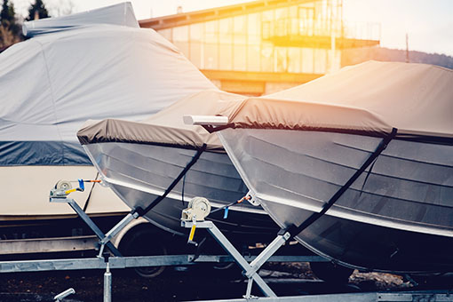 Row of boats in storage for the winter under the awning. Warehou
